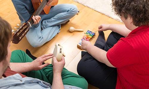 a music therapy session with three people